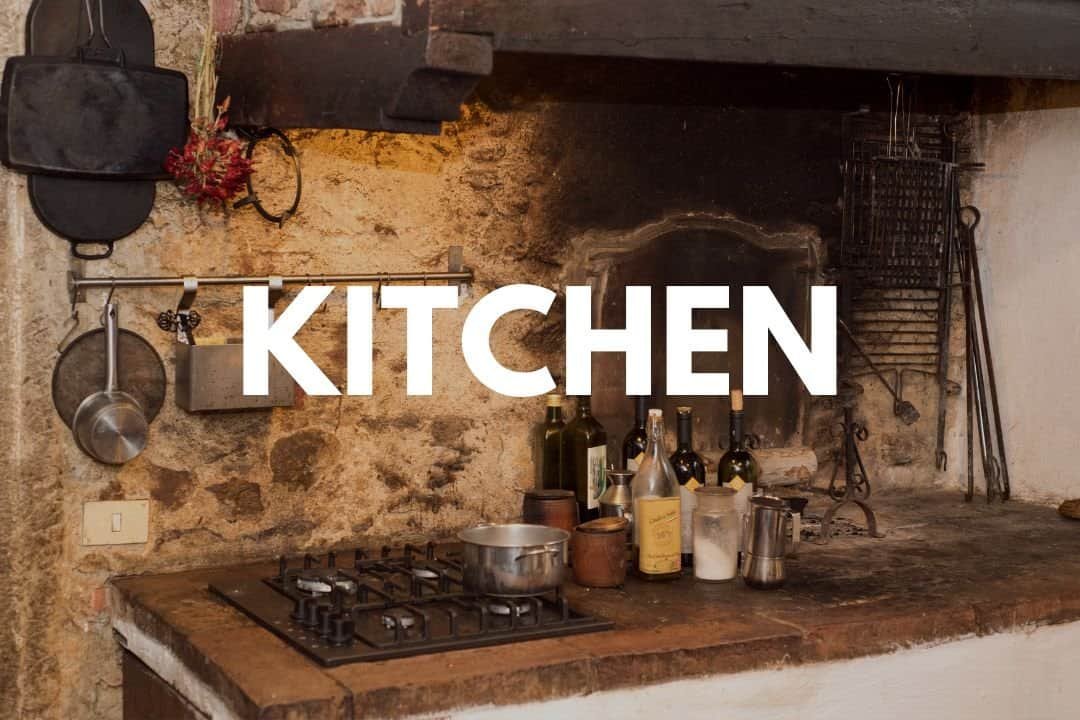 Rustic kitchen with vintage brick wall, cast iron cookware, and wooden countertop, emphasizing cozy home cooking and farmhouse aesthetic.