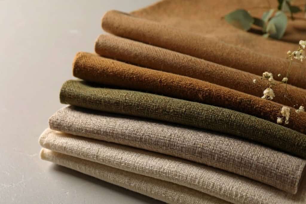 Soft, natural-toned fabric swatches in earthy shades for sustainable and eco-friendly home decor and interior design.