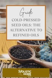 Cold-pressed seed oils arranged in bowls with fresh herbs and wooden backdrop, highlighting natural, healthy cooking ingredients.